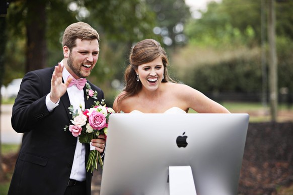 September 27, 2020, Youngsville, NC, USA: John Michael and Carrie Simpson greet their online guests watching a livestream of their wedding ceremony on Sunday, Sept. 27, 2020, in Youngsville. Youngsvil ...