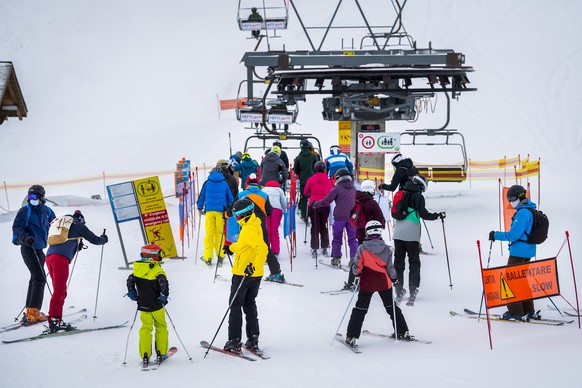 Des personnes pratiquent le ski sur les pistes du domaine skiable en faisant la queue au depart d&#039;un telesiege lors de la crise du Coronavirus (Covid-19) le dimanche 27 decembre 2020 a Leysin dan ...