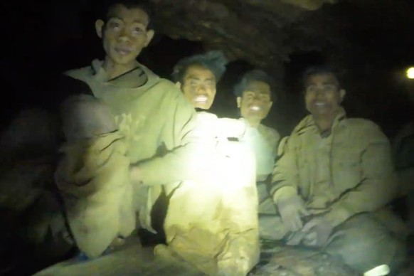 This image made from the video provided by Benz Norrased Palasing Seascout Diving shows the villagers who were trapped and found in a flooded cave in Xaisomboun province, Laos, Wednesday, May 27, 2026 ...