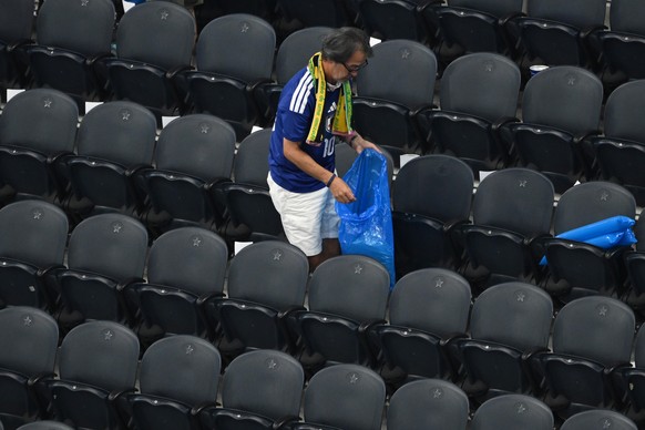 Japan fans clean up trash in the stadium following the World Cup Group F soccer match between the Netherlands and Japan in Arlington, Texas, near Dallas, Sunday, June 14, 2026. (AP Photo/Jessica Tobia ...