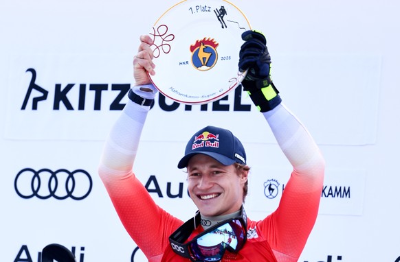 epa11849675 First placed Marco Odermatt of Switzerland poses with the trophy on the podium after the Men&#039;s Super G race at the FIS Alpine Skiing World Cup in Kitzbuehel, Austria, 24 January 2025. ...