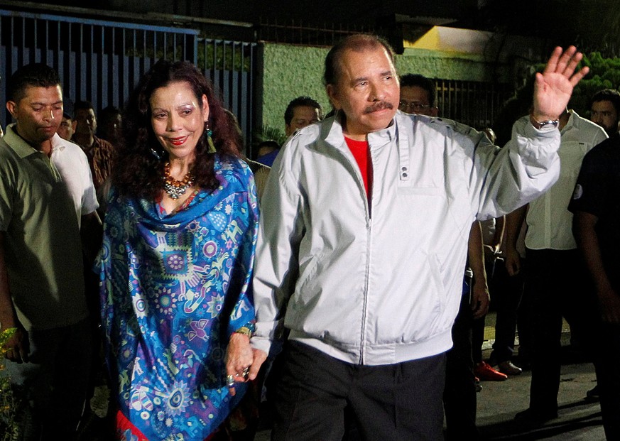 Daniel Ortega, Nicaragua&#039;s current president and presidential candidate from the ruling Sandinista National Liberation Front, waves to the media beside vice presidential candidate, his wife, Rosa ...