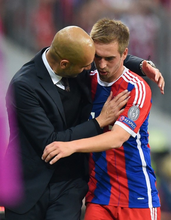 MUNICH, GERMANY - MAY 12: Josep Guardiola head coach of Bayern Muenchen speaks to Philipp Lahm of Bayern Muenchen during the UEFA Champions League semi final second leg match between FC Bayern Muenche ...