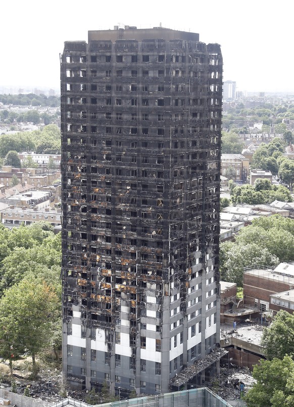 The burnt Grenfell Tower apartment building stands testament to the recent fire in London, Friday, June 23, 2017. British officials have ordered an immediate examination Friday, into a fridge-freezer  ...
