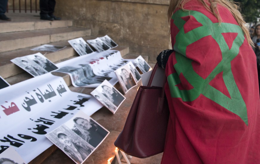 epa07249554 Placards and candles are placed outside the St. Peter&#039;s Cathedra in Rabat, Morocco, 26 December 2018. According to media reports, four Moroccan nationals arrested on suspicion of havi ...