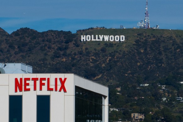A Netflix sign is displayed atop a building in Los Angeles, Thursday, Dec. 18, 2025, with the Hollywood sign in the distance. (AP Photo/Jae C. Hong)
Warner Bros