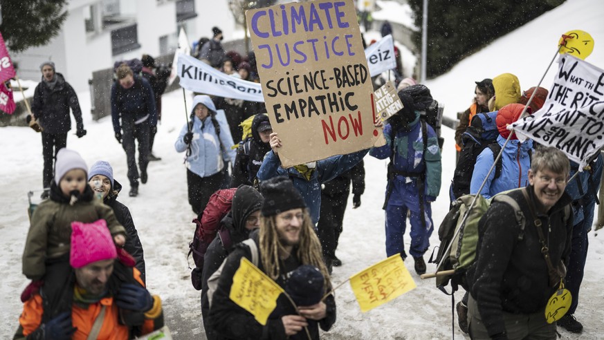 People attend a climate protest rally by Swiss party &#039;Juso&#039; and the organization &#039;Strike WEF&#039; on the eve of the 52nd annual meeting of the World Economic Forum (WEF) in Davos, Swit ...
