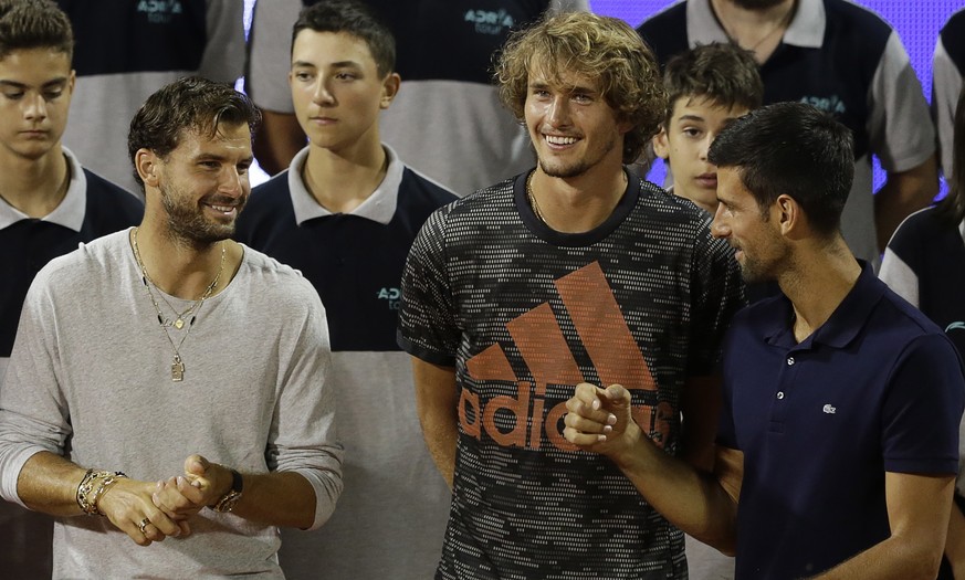 epa08485674 Alexander Zverev (C) of Germany, Grigor Dimitrov (L) of Bulgaria and Novak Djokovic (R) of Serbia chat after the final match at the Adria Tour tennis tournament in Belgrade, Serbia, 14 Jun ...