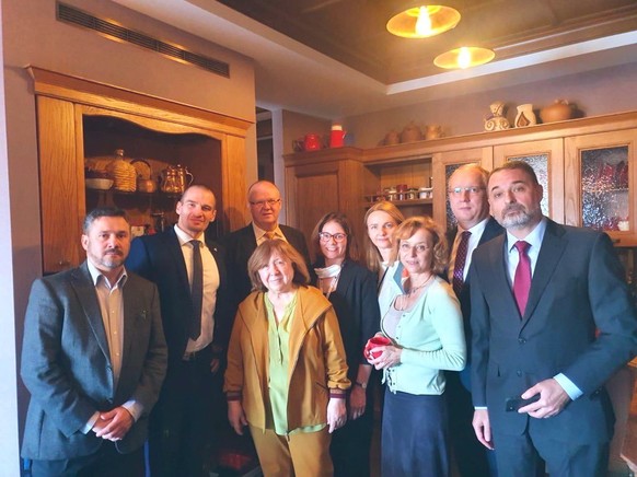 epa08656993 A handout photo made available by the Swedish Foreign Ministry shows foreign diplomats with Nobel Literature Prize winner, and Belarusian writer Svetlana Alexievich (front, 3-L) at her hom ...