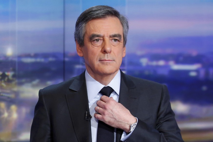 Francois Fillon, former French prime minister, member of The Republicans political party and 2017 presidential candidate of the French centre-right, adjusts his tie prior to a prime-time news broadcas ...