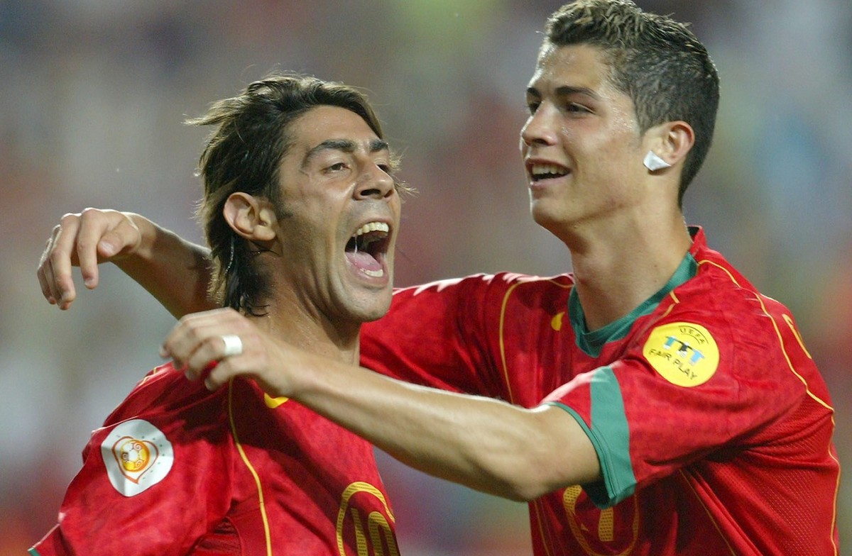 Portuguese midfielder Rui Costa (L) celebrates with his team mate Cristiano Ronaldo (R) after scoring his team's second goal against Russia during their Group A soccer match as part of the Europe ...