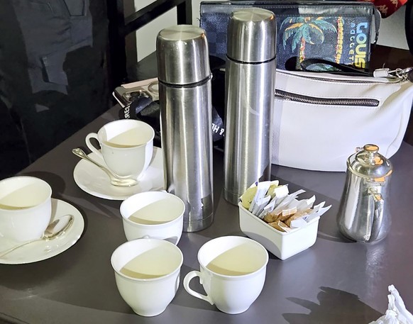 epa11483008 A handout photo made available by the Royal Thai Police shows cups of tea on a table inside a hotel room where six people were found dead of poisoning at Grand Hyatt Erawan Hotel in Bangko ...