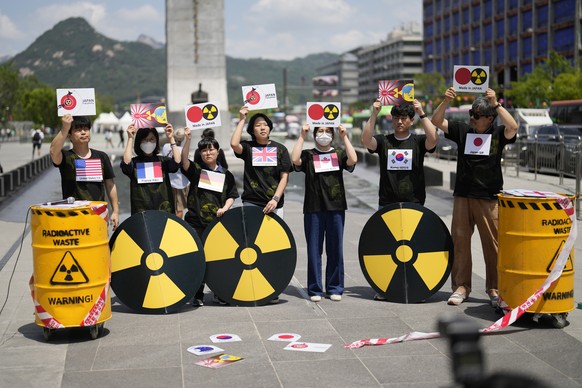 Members of a citizens' group hold placards during a rally calling on South Korea and the G7 countries to voice their objection to the Japanese government's decision to release purified radioactive water from Fuku...