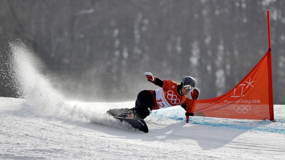 Nevin Galmarini, of Switzerland, runs the course during the men's parallel giant slalom quarterfinals at Phoenix Snow Park at the 2018 Winter Olympics in Pyeongchang, South Korea, Saturday, Feb. 24, 2018. (AP Photo/Gregory Bull)