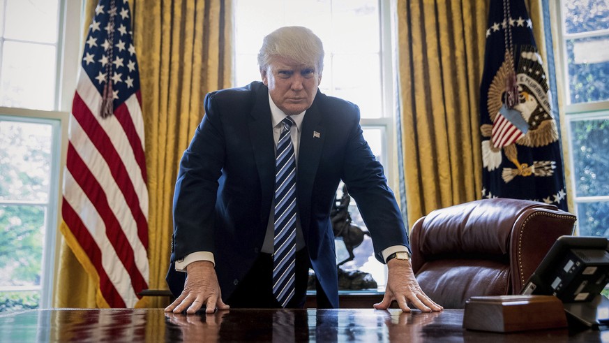 President Donald Trump poses for a portrait in the Oval Office in Washington, Friday, April 21, 2017. With his tweets and his bravado, Trump is putting his mark on the presidency in his first 100 days ...