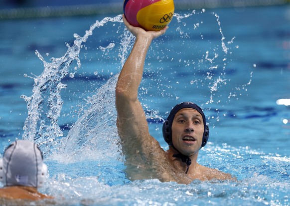 epa09405609 Andrija Prlainovic (R) of Serbia in action during the Men&#039;s Water Polo Gold medal match between Greece and Serbia at the Tokyo 2020 Olympic Games at the Tatsumi Water Polo Centre in T ...