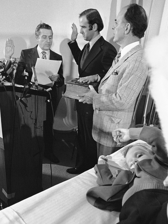 FILE - In this Jan. 5, 1973 file photo, four-year-old Beau Biden, foreground, plays near his father, Joe Biden, center, being sworn in as the U.S. senator from Delaware, by Senate Secretary Frank Vale ...