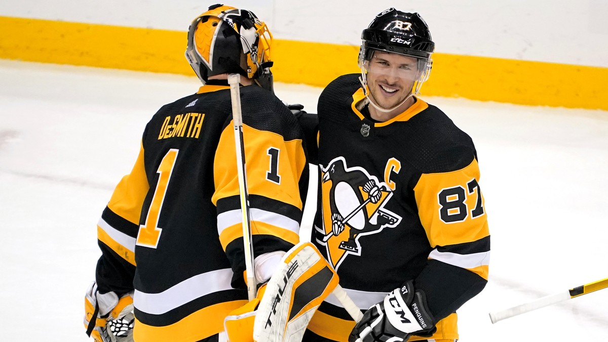 Pittsburgh Penguins' Sidney Crosby (87) celebrates with goaltender Casey DeSmith after a 4-2 win over the New Jersey Devils in an NHL hockey game in Pittsburgh, Saturday, April 24, 2021. (AP Phot ...