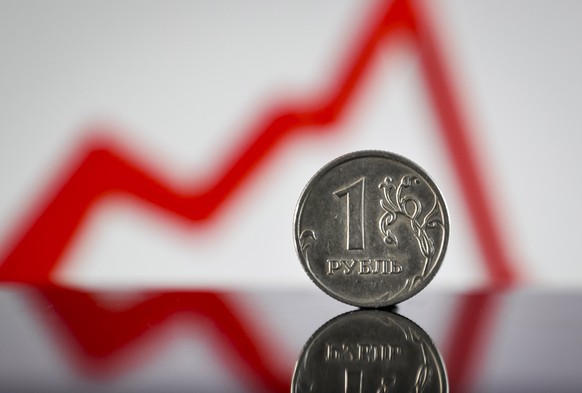 epa09863442 A photo illustration shows a Russian ruble coin in Moscow, Russia, 01 April 2022. Russian President Putin announced on 31 March that he signed a decree on transitioning to payments for Rus ...