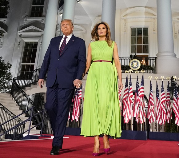 President Donald Trump and first lady Melania Trump arrive for his acceptance speech to the Republican National Committee Convention on the South Lawn of the White House, Thursday, Aug. 27, 2020, in W ...