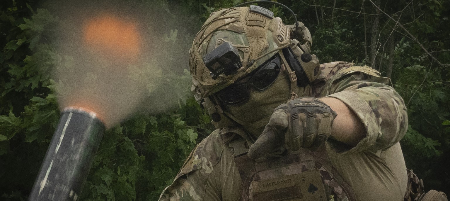 A Ukrainian soldier gestures as he fires towards Russian positions on the frontline in Zaporizhzhia region, Ukraine, Saturday, June 24, 2023. (AP Photo/Efrem Lukatsky)