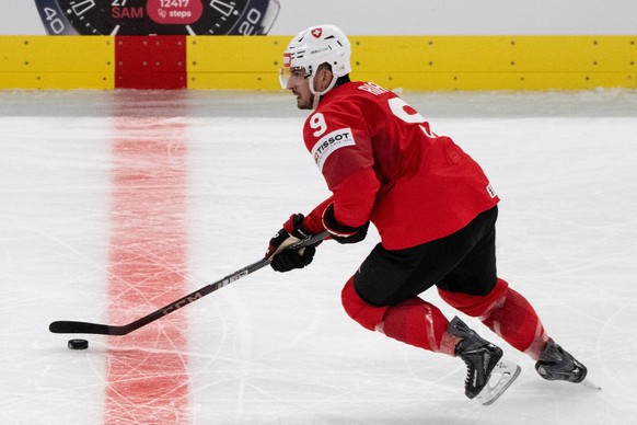 Switzerland's Damien Riat skates with the puck during the Group A preliminary round game between Switzerland and Latvia at the men's ice hockey world championship, Saturday, May 16, 2026, in ...