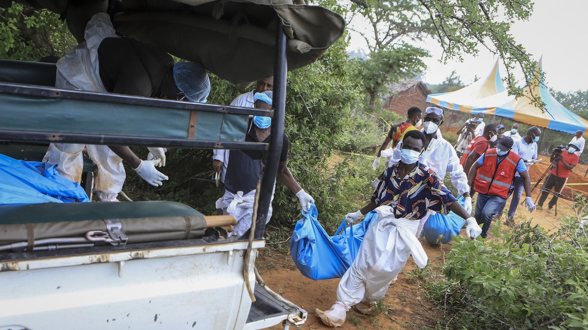 Police and local residents load the exhumed bodies of victims of a religious cult into the back of a truck in the village of Shakahola, near the coastal city of Malindi, in southeastern Kenya Sunday,  ...
