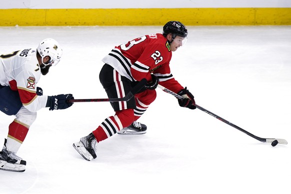 Chicago Blackhawks center Philipp Kurashev, right, controls the puck past Florida Panthers defenseman Radko Gudas during the second period of an NHL hockey game in Chicago, Sunday, Feb. 20, 2022. (AP  ...