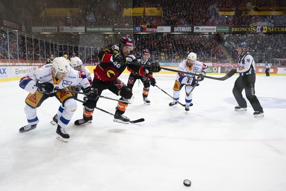 Zugs Sven Senteler, Zugs Marc Michaelis, Berns Joona Luoto, Berns Simon Kindschi, und Zugs Arno Nussbaumer, von links, kaempfen um den Puck, im zweiten Eishockey Playoff Viertelfinal Spiel der Nationa ...