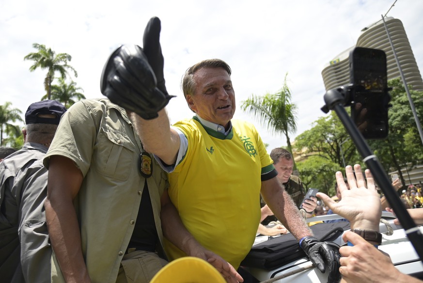 FILE - Brazil&#039;s President Jair Bolsonaro flashes a thumbs up as he greets supporters, wearing a Brazil soccer jersey, as he campaigns in Praca da Liberdade or Liberty Square, in Belo Horizonte, B ...