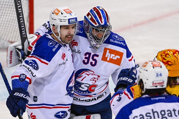 Die Zuercher Patrick Geering, links, und Torhueter Ludovic Waeber, jubeln nach gewonnenem Penaltyschiessen im Eishockey Meisterschaftsspiel der National League zwischen dem SC Bern und den ZSC Lions,  ...