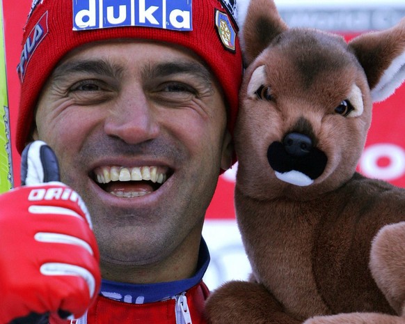 Italy's Kristian Ghedina celebrates on the podium after his second place time in the men's World Cup Downhill race in Chamonix, France, Saturday, 08 January 2005. Johann Grugger of Austria won the rac ...