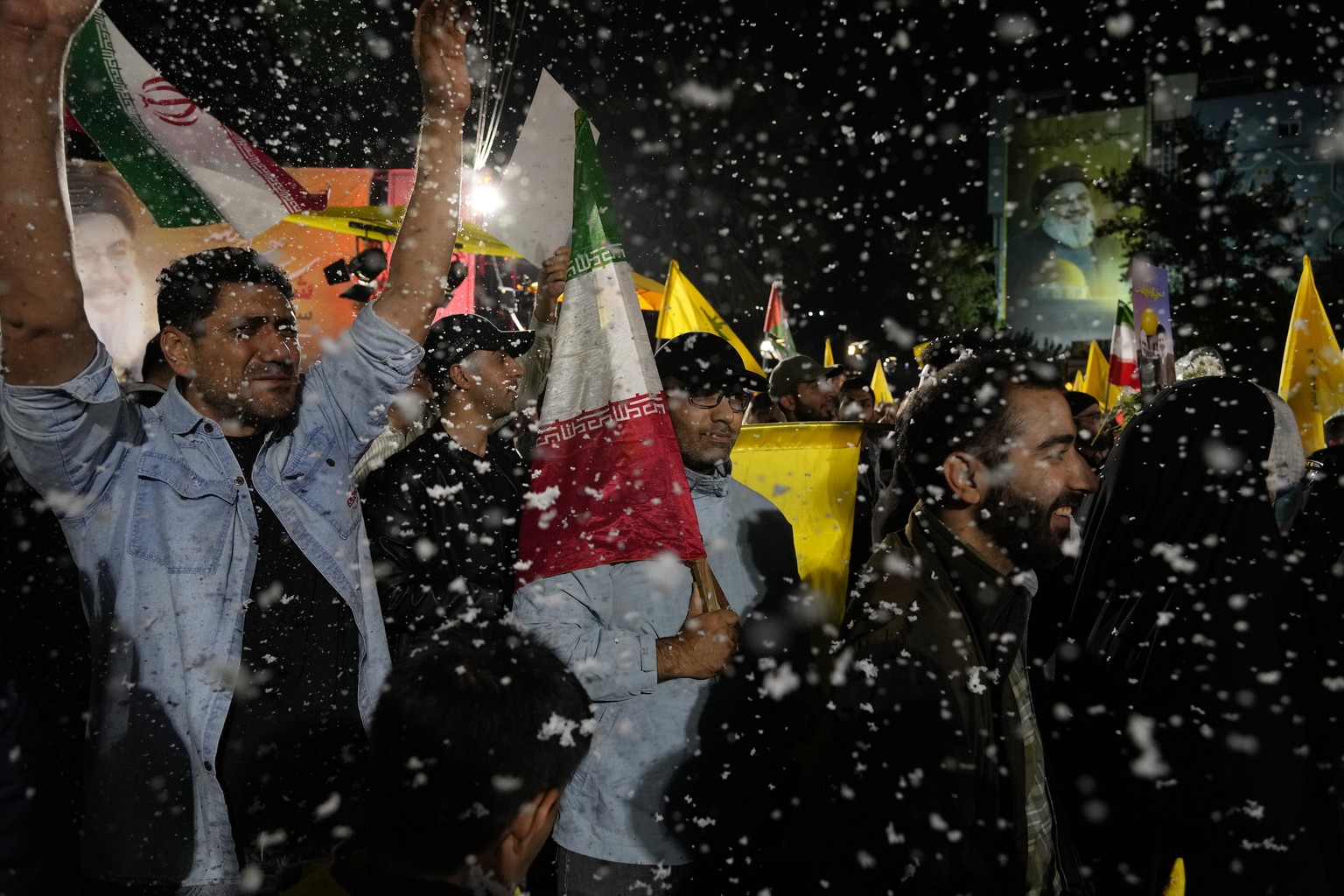Demonstrators cheer as artificial snow sprayed in an anti-Israeli gathering celebrating Iran&#039;s missile strike against Israel, at Felestin (Palestine) Sq. in Tehran, Iran, Tuesday, Oct. 1, 2024. ( ...