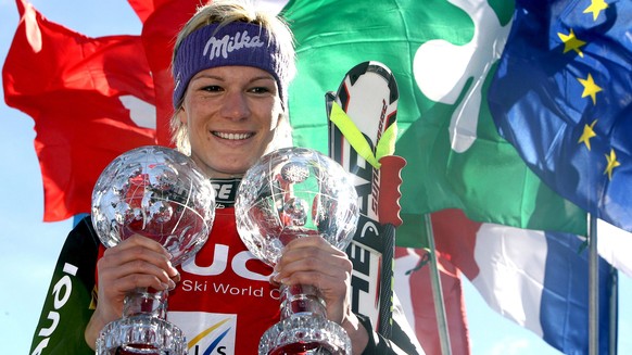 epa04133481 (FILE) A file picture dated 13 March 2008 shows Germany's Maria Riesch posing with her crystal globe trophies on the podium after winning the women's overall Super-G and the Supe ...