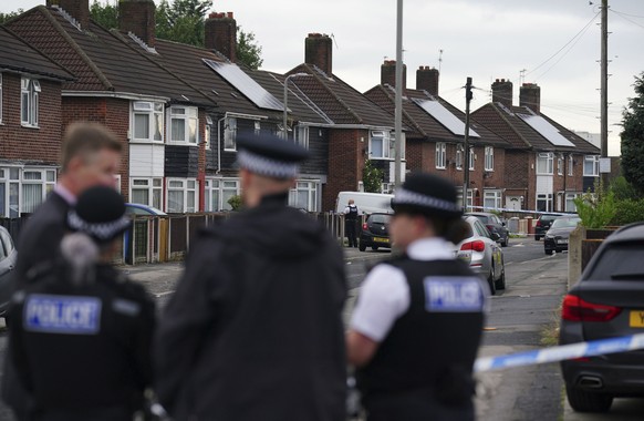 Police officers near the scene in Kingsheath Avenue, Knotty Ash, where a nine-year-old girl was fatally shot, in Liverpool, England, Tuesday, Aug. 23, 2022. Officers from Merseyside Police have starte ...