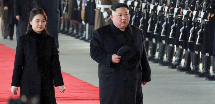 In this Monday, Jan. 7, 2019, photo provided on Tuesday, Jan. 8, 2019 by the North Korean government, North Korean leader Kim Jong Un walks with his wife Ri Sol Ju at Pyongyang Station in Pyongyang, N ...