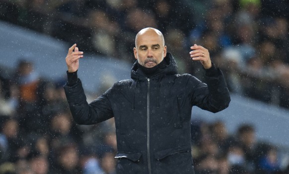 epa11009688 Pep Guardiola, manager of Manchester City reacts during the English Premier League soccer match between Manchester City and Tottenham Hotspur, in Manchester, Britian, 03 December 2023. EPA ...