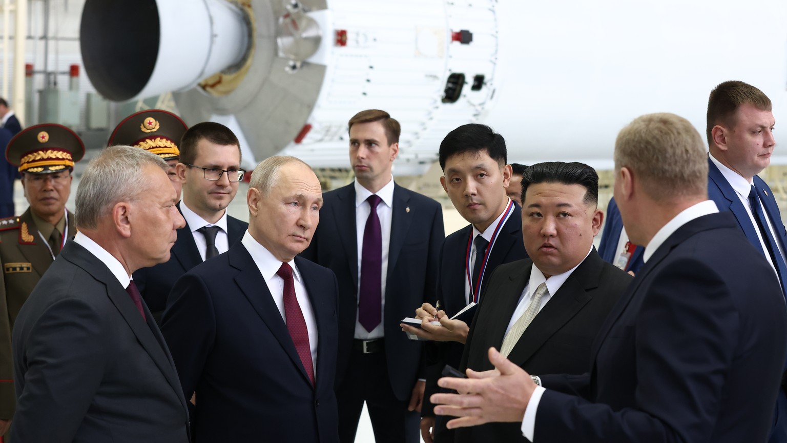 epa10857899 Russian President Vladimir Putin (2nd-L) and North Korean leader Kim Jong Un (3d-R), accompanied by head of Russian state space corporation Roscosmos Yuri Borisov (L), visit the Vostochny  ...
