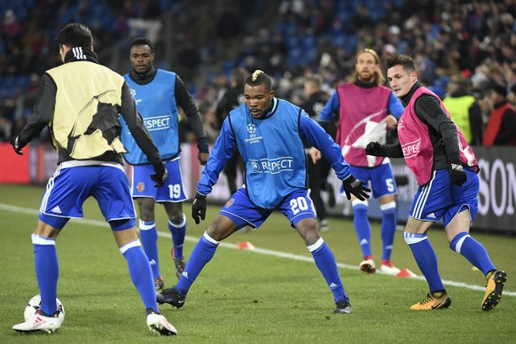 Basel&#039;s Mohamed Elyounoussi, Dimitri Oberlin, Geoffroy Serey Die, Michael Lang and Taulant Xhaka, from left, warm up ahead of the UEFA Champions League round of sixteen first leg soccer match bet ...