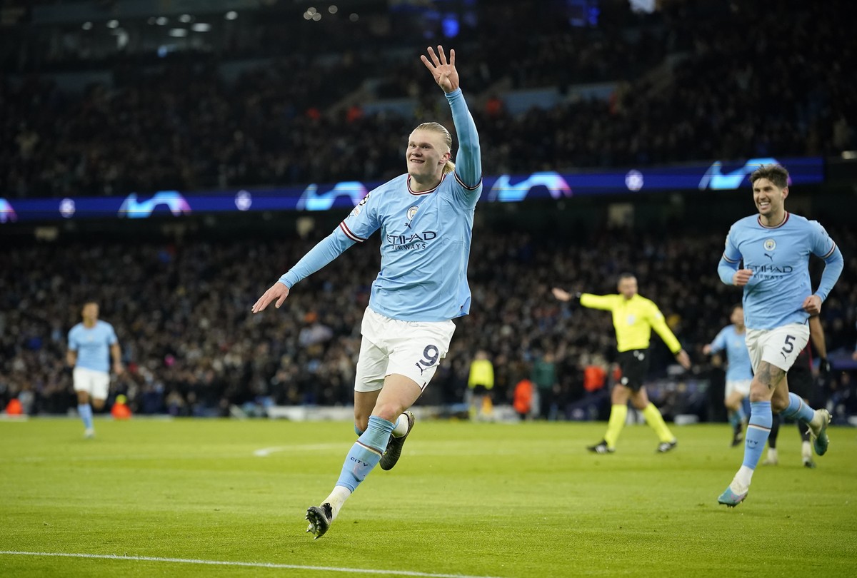 Manchester City's Erling Haaland celebrates after scoring his side's 5th goal during the Champions League round of 16 second leg soccer match between Manchester City and RB Leipzig at the Et ...