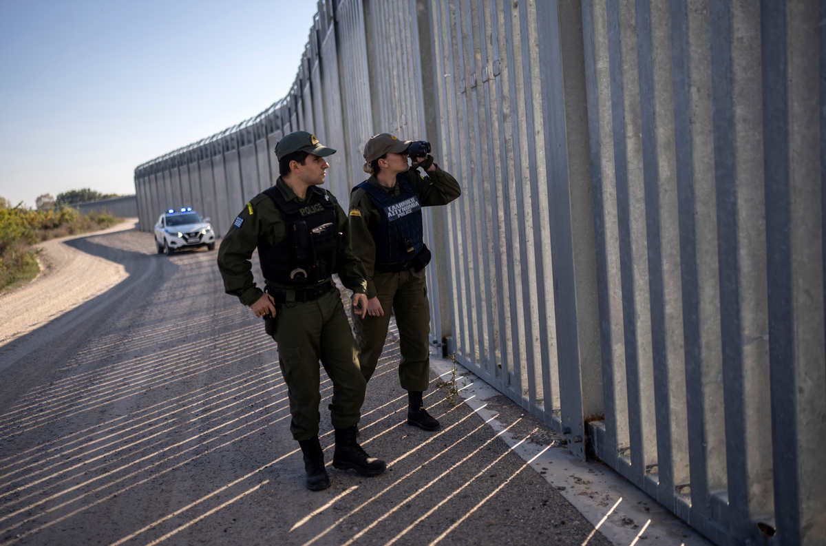 FILE - Police border guards patrol along a border wall near the town of Feres, along the Evros River which forms the frontier between Greece and Turkey on Sunday, Oct. 30, 2022. Greece prevented some  ...
