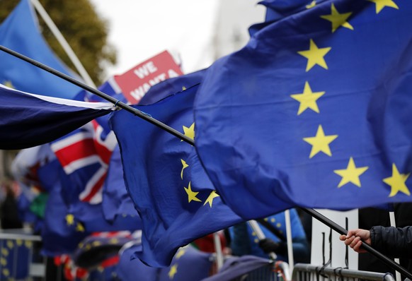 The EU and British flags wave at the demonstrations area near the parliament building in London, Wednesday, Jan. 16, 2019. British lawmakers overwhelmingly rejected Prime Minister Theresa May&#039;s d ...