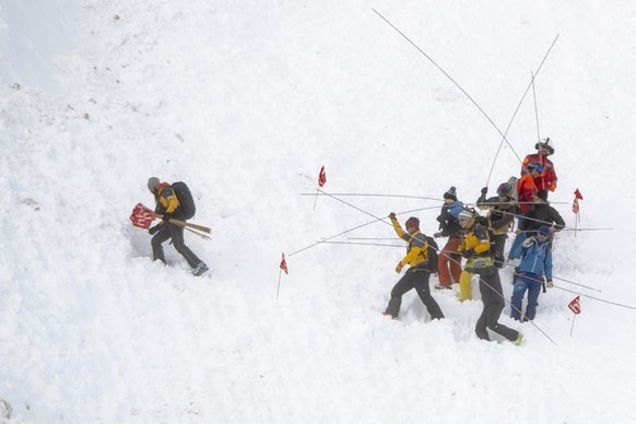 Rescue forces with avalanche probes still search for missed persons after an avalanche swept down a ski piste in the central town of Andermatt in canton Uri, Switzerland, Thursday, December 26, 2019.  ...
