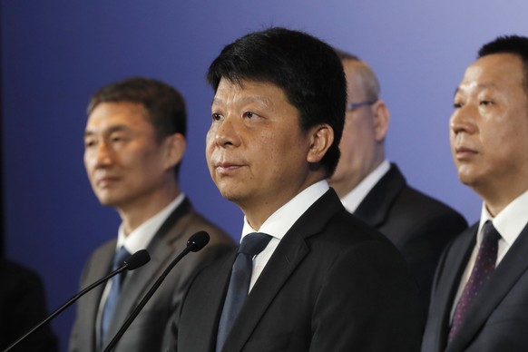 Huawei Rotating Chairman Guo Ping, center, speaks in front of other executives during a press conference in Shenzhen city, China&#039;s Guangdong province, Thursday, March 7, 2019. Chinese tech giant  ...