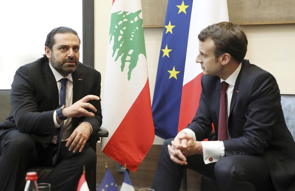 Lebanese Prime Minister Saad Hariri, left, speaks with French President Emmanuel Macron as they attend the international CEDRE conference in Paris Friday, April 6, 2018.International donors are set to ...