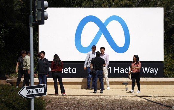 epa10581101 People gather in front of the Meta sign outside Meta corporate headquarters in Menlo Park, California, USA, 19 April 2023. According to media reports, thousands of workers are going to los ...