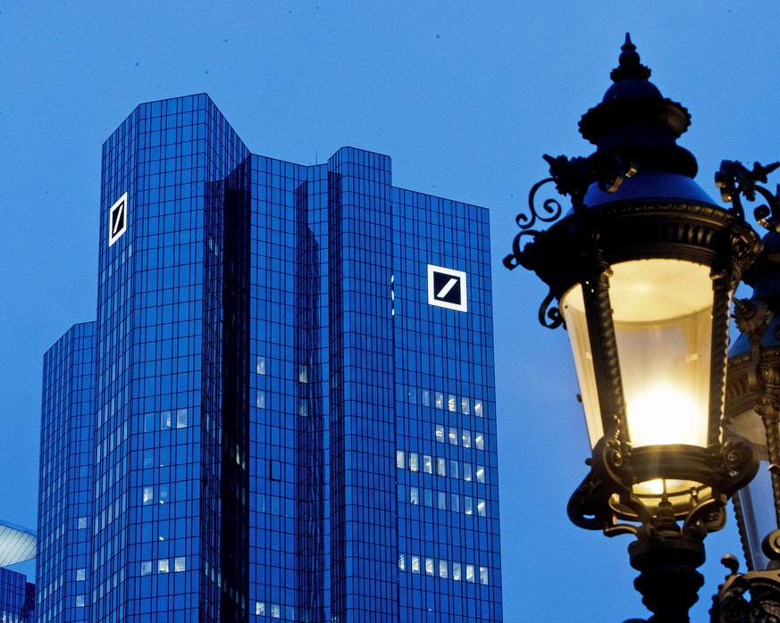 The Deutsche Bank headquarters is seen behind a lamp ahead of the annual press conference in Frankfurt, Germany, Friday, Feb. 1, 2019. (AP Photo/Michael Probst)