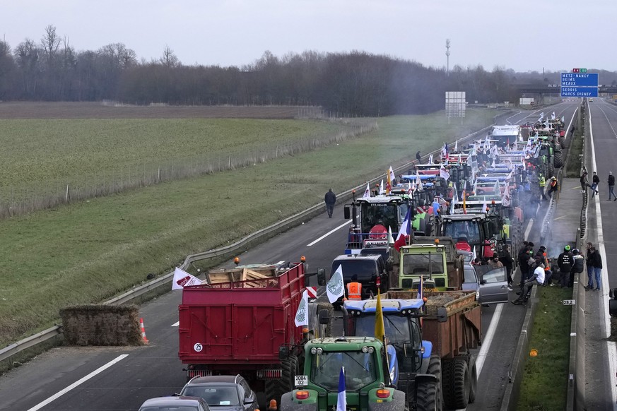 Farmers block the highway Tuesday, Jan. 30, 2024 in Jossigny, east of Paris. With protesting farmers camped out at barricades around Paris, France&#039;s government hoped to calm their anger with more ...