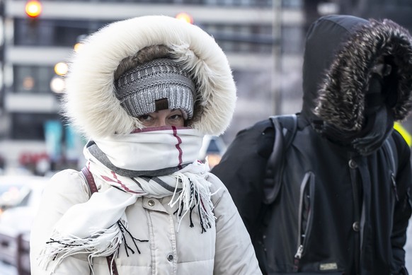 A bundled-up commuter makes their way through the loop early Wednesday, Jan. 30, 2019 in Chicago. A deadly arctic deep freeze enveloped the Midwest with record-breaking temperatures triggering widespr ...