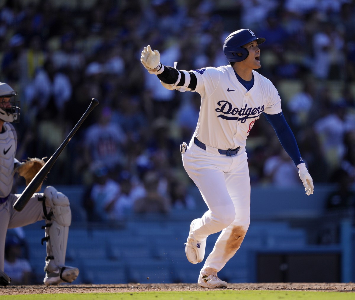 Los Angeles Dodgers' Shohei Ohtani drops his bat as he heads to first for a solo home run during the ninth inning of a baseball game against the Colorado Rockies, Sunday, Sept. 22, 2024, in Los A ...